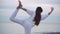 Beautiful woman working out on beach.