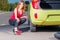 Beautiful woman with with a wrench near the car