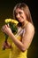 Beautiful woman in yellow dress with rose flowers