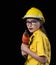 A beautiful woman in the yellow technician uniform holds a drill used in the construction