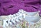 Beautiful womanly shoes with flowers and purple jacket on the background.