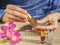 Beautiful womans hands holding a small vial of scented oil. Arab Attar.