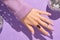 Beautiful womans hands in sweeter with purple fashionable spring nail design