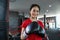 Beautiful women Asian boxer happy and fun fitness boxing and Punching A Bag With wearing boxing gloves