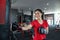 Beautiful women Asian boxer happy and fun fitness boxing and Punching A Bag With wearing boxing gloves