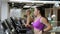 Beautiful women are exercising on treadmill in modern sports club.