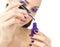 Beautiful women eyes with stylish make-up and hands with purple