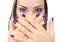 Beautiful women eyes with stylish make-up and hands with purple