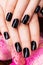 Beautiful women hands with black manicure