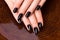 Beautiful women hands with black manicure