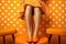 Beautiful women& x27;s feet in orange shoes. Girl in orange dress on orange background in circle