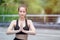 Beautiful women sportswear practicing yoga sitting pose folded hands. Prayer position yoga outdoor on floor. Relaxation yoga