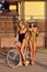 Beautiful women in swimsuits posing near a vintage bike
