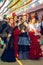 Beautiful women in traditional and colorful dress enjoy April Fair, Seville Fair Feria de Sevilla.