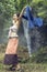 Beautiful women in traditional dress dancing at waterfall