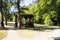 Beautiful wooden arbour and trees in the park in autumn.