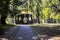 Beautiful wooden arbour and trees in the park in autumn.