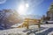 Beautiful wooden bench seating in snow mountain Alp sun shine da