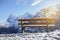 Beautiful wooden bench seating in snow mountain Alp sunrise with