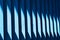 Beautiful wooden blue slats. A streak of sunlight on a wooden fence. Bright abstract background. Element of finishing the facade