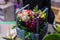 Beautiful wooden box of crimson, white and yellow flowers decorated with green leaves