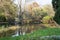 Beautiful wooden bridge over mirrored pond in the european autumn park