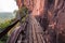 Beautiful Wooden bridge in red cliffside at Wat Phu tok mountain. Bueng Kan, Thailand