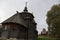 Beautiful wooden brown Christian old Church on a rainy day in summer