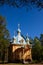 Beautiful wooden chapel of the Ascension of the Lord of the Valaam Monastery. Vertical photo of a chapel with blue domes in the
