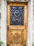 Beautiful Wooden door with Swan Iron Wrought Pattern on old house in Gruyere village, Fribourg canton, Switzerland, Europe