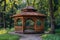 Beautiful wooden gazebo in a serene summer park setting surrounded by lush greenery