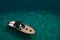 Beautiful wooden sports motor boat with a black awning, slowly floats on the clear azure water of the Adriatic Sea, top