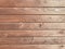 Beautiful wooden texture of horizontal multi-colored boards with knots on a brown wall surface. The background. Texture