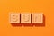 Beautiful word sun on wooden cubes orange background , great design for any purposes. Abstract background. Summer