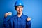 Beautiful worker woman wearing hardhat and uniform celebrating 8th march womens day pointing and showing with thumb up to the side