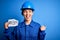 Beautiful worker woman wearing hardhat and uniform celebrating 8th march womens day pointing and showing with thumb up to the side