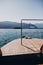 Beautiful yacht wooden deck, boat nose, sailing to Borromean Islands on Lago Maggiore, Stresa city, Italy. Relaxing on lake