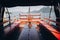 Beautiful yacht wooden deck with helm wheel sailing to Borromean Islands on Lago Maggiore, Stresa city, Italy. Relaxing on lake