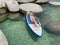 Beautiful yang lady relaxes on the paddle board