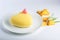 Beautiful yellow cake in the shape of a heart filled with white souffle and pineapple. Concept design desserts