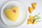 Beautiful yellow cake in the shape of a heart filled with white souffle and pineapple. Concept design desserts