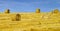 Beautiful yellow hill with haystacks at sunset