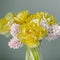 Beautiful yellow peony tulips and pink hyacinth flower bouquet on white dresser