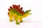 Beautiful yellow red stegosaurus stands on a white background