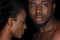 beautiful young african american couple with water drops on faces posing