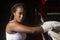 Beautiful young afro girl boxing athlete looking at camera inside the gym, strength, inspiration, determination