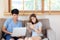 Beautiful young asian couple cheerful freelance working with man using laptop and woman using tablet on couch