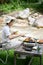 Beautiful young Asian female making a barbecue lunch for the camping party at campground