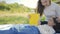 Beautiful young asian mother and daughter doing picnic and reading tale in yellow books at green park.