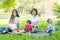 Beautiful young asian parent family portrait picnic in the park, kid or children and mother love happy and cheerful